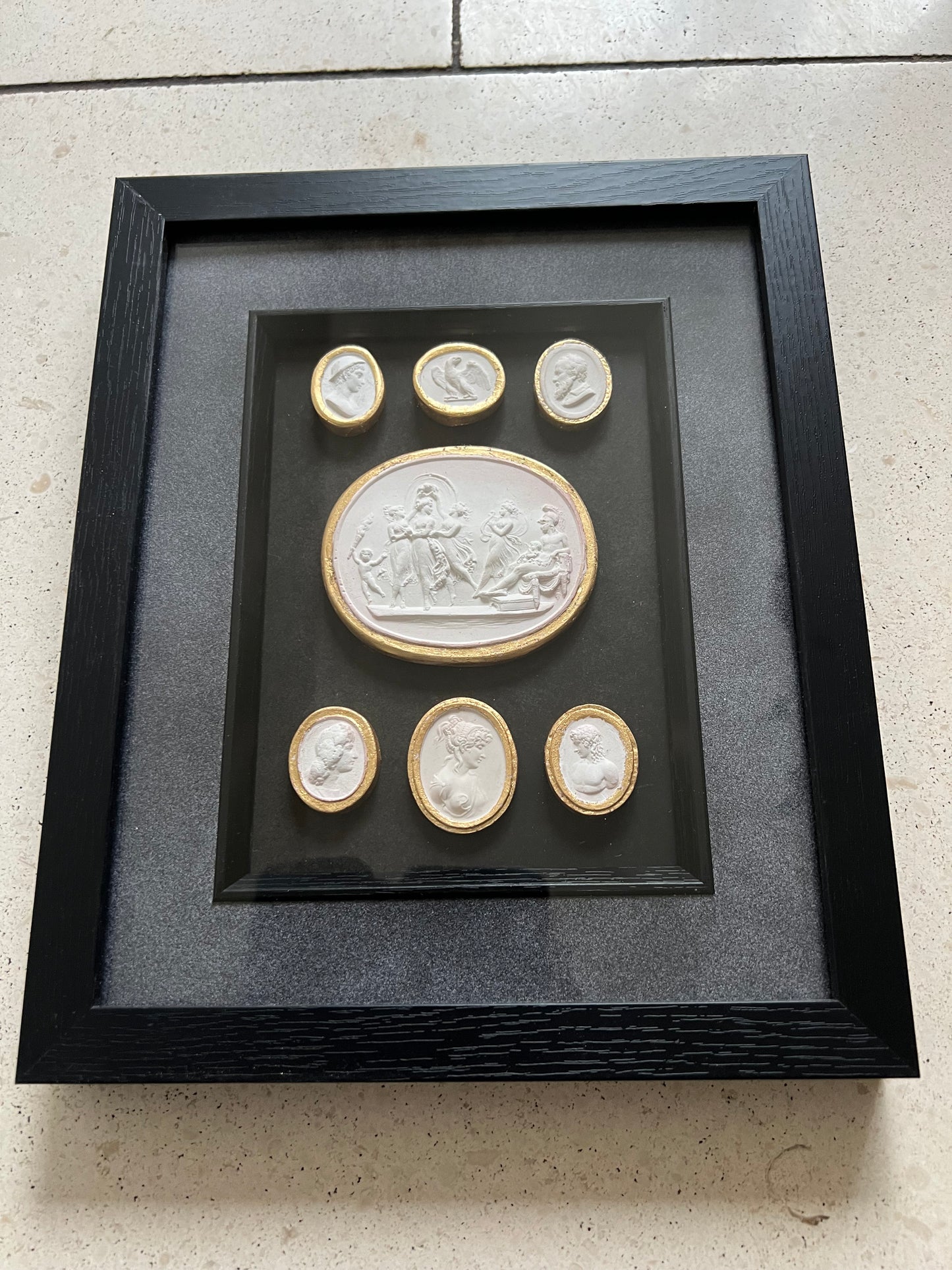 Set of Seven Intaglio's With Gold leaf And Black Frame