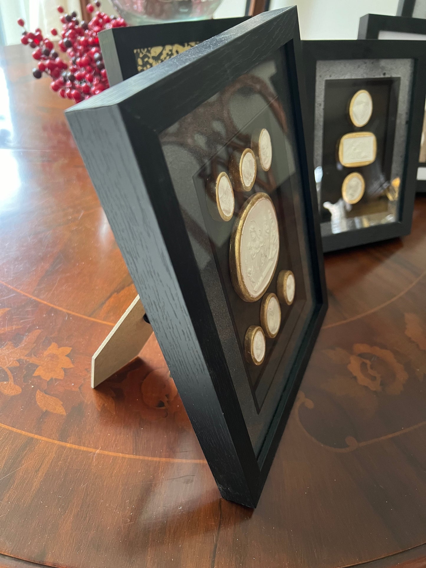 Set of Seven Intaglio's With Gold leaf And Black Frame