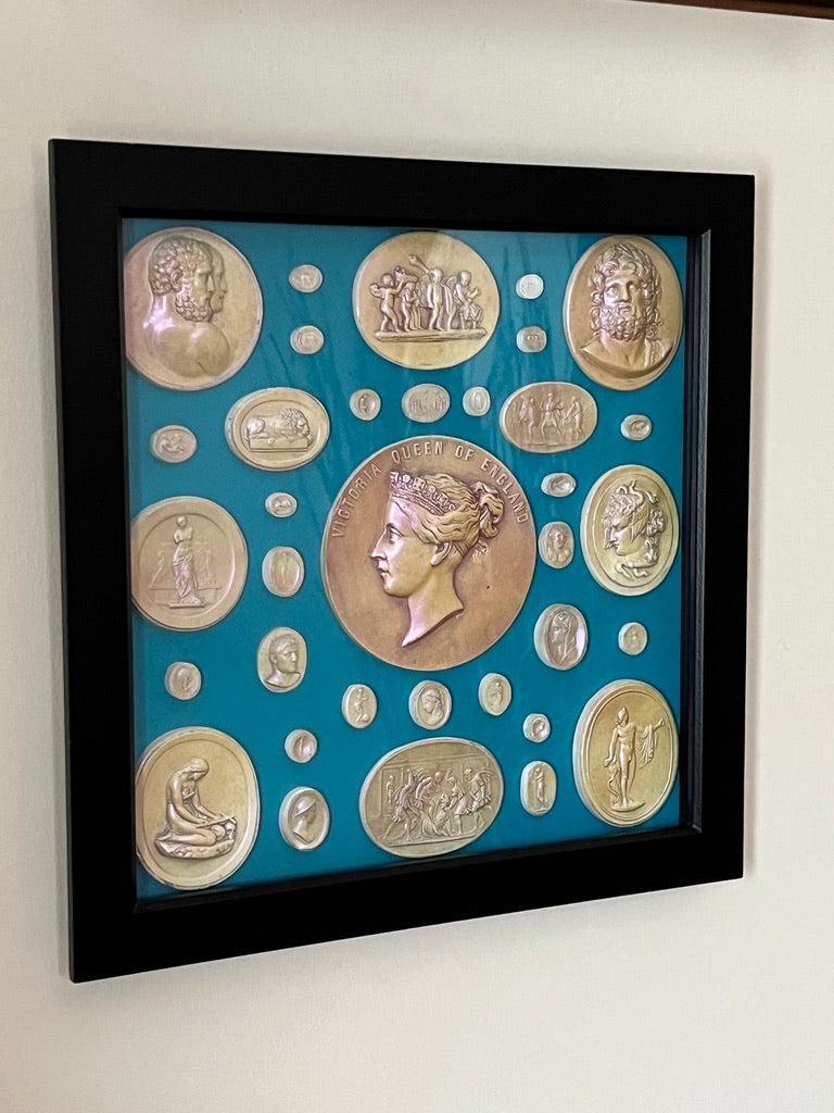 Framed and glazed Intaglios in Pearl on a blue background